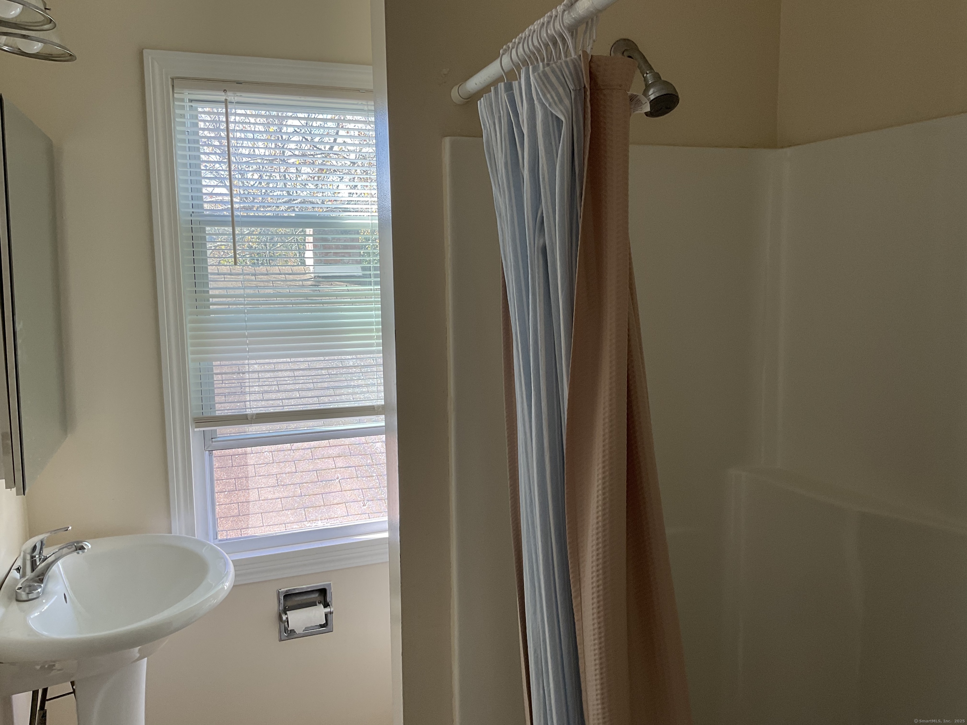 22 Oak Street Naugatuck, CT 06770 - Photo 3 of 7 a bathroom with a sink a mirror and a shower