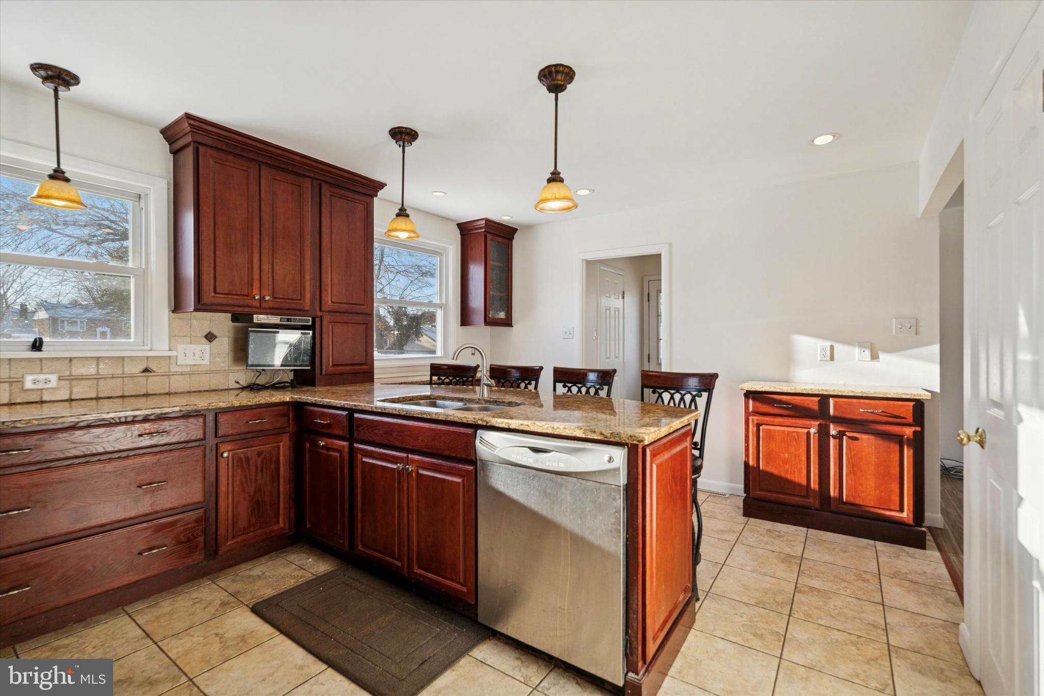 725 Springdell Road King of Prussia, PA 19406 - Photo 13 of 29 a kitchen with stainless steel appliances granite countertop wooden cabinets stove top oven and sink