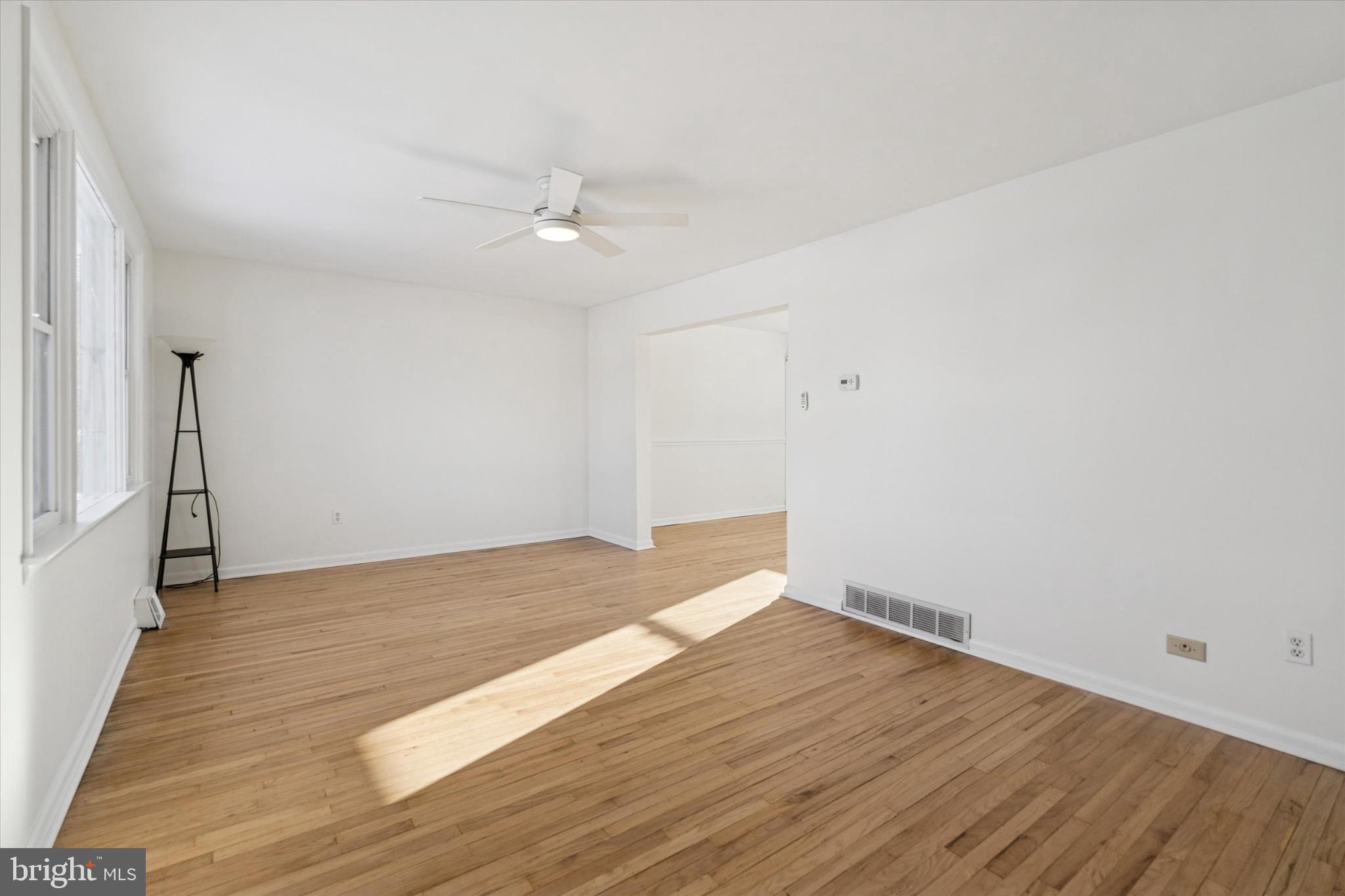 725 Springdell Road King of Prussia, PA 19406 - Photo 7 of 29 an empty room with wooden floor and ceiling fan