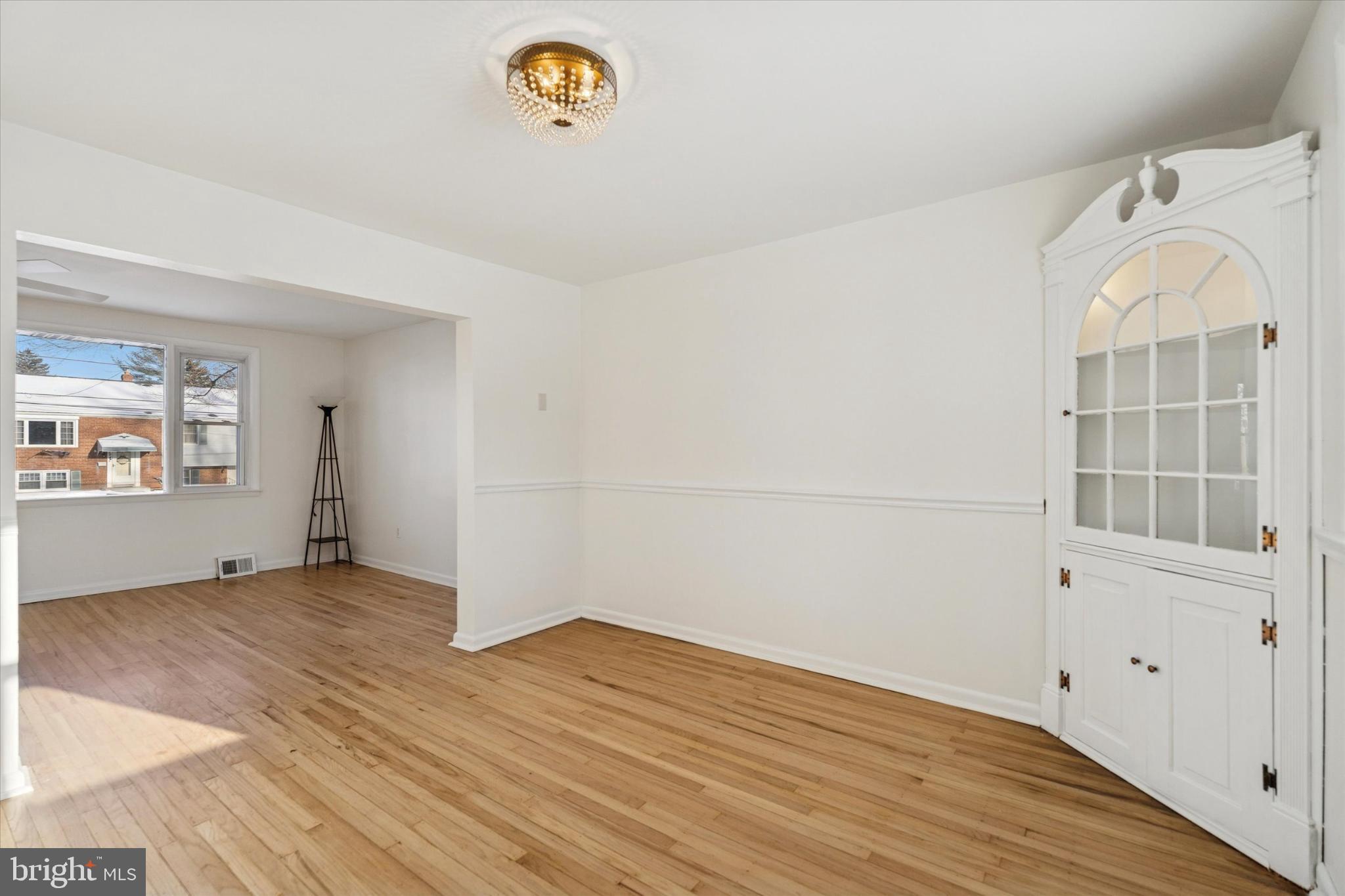 725 Springdell Road King of Prussia, PA 19406 - Photo 9 of 29 an empty room with wooden floor and windows