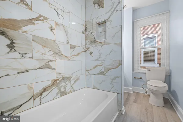 a bathroom with a bathtub and a toilet