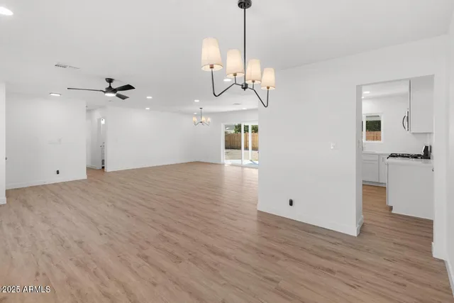 a view of a room with wooden floor and white walls