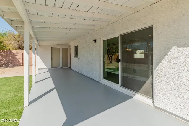 a view of a backyard with swimming pool