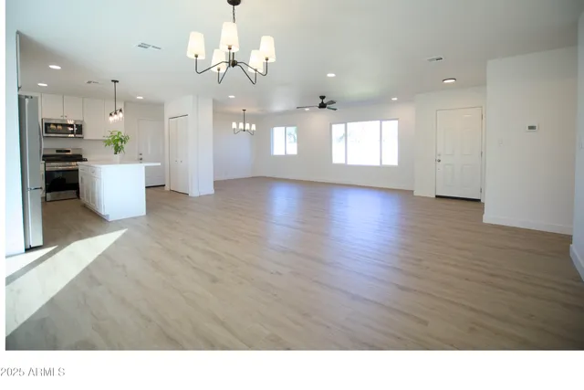 a view interior of a house with kitchen view and wooden floor
