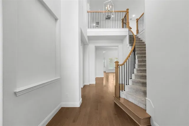 a view of entryway and hall with wooden floor