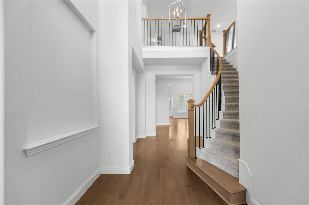 3811 Pepper Grass Lane Prosper, TX 75078 - Photo 10 of 40 a view of entryway and hall with wooden floor