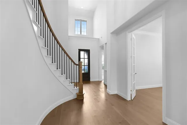 a view of a hallway with wooden floor and entryway