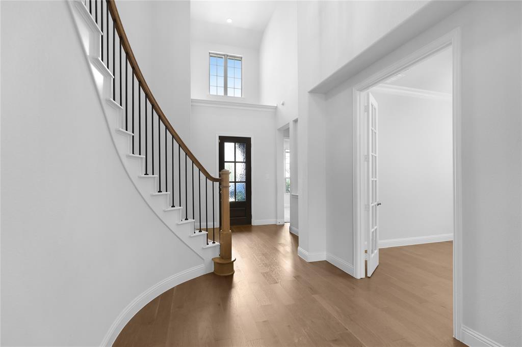 3811 Pepper Grass Lane Prosper, TX 75078 - Photo 11 of 40 a view of a hallway with wooden floor and entryway