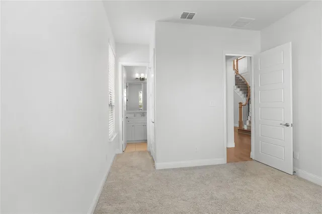 an empty room with a bathroom and a sink