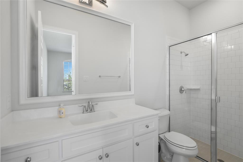 3811 Pepper Grass Lane Prosper, TX 75078 - Photo 16 of 40 a bathroom with a sink a toilet and a mirror