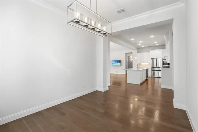 a view of a kitchen with a white cabinet and a kitchen view