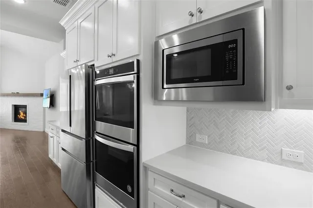 a kitchen with stainless steel appliances a refrigerator microwave and sink