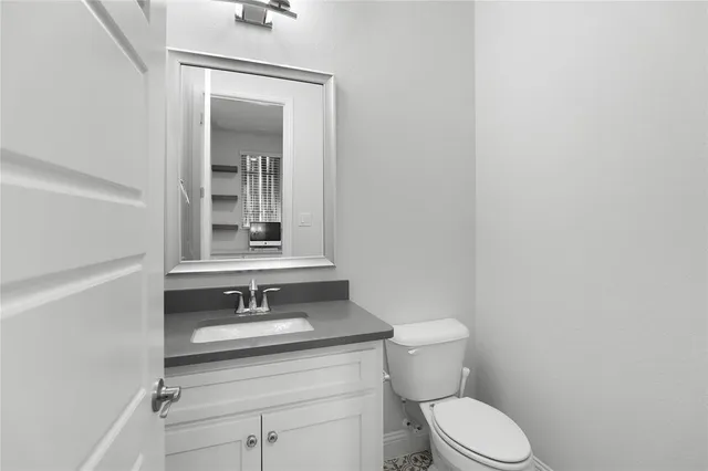 a bathroom with a sink a toilet and mirror