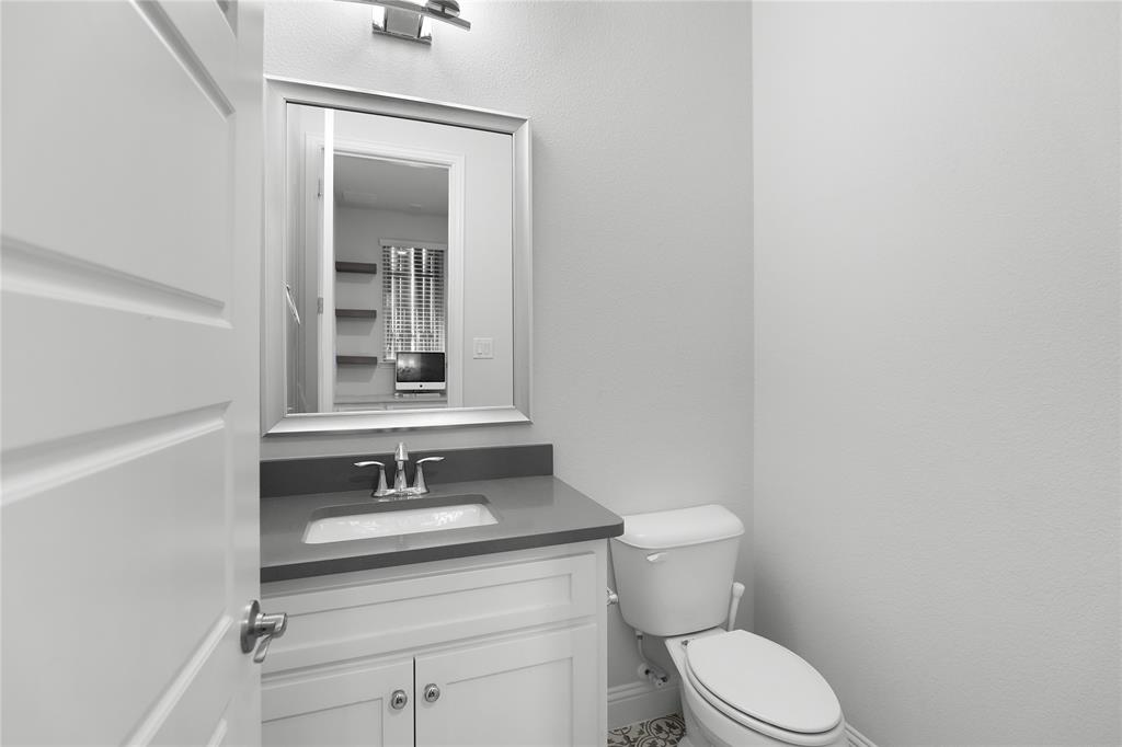 3811 Pepper Grass Lane Prosper, TX 75078 - Photo 30 of 40 a bathroom with a sink a toilet and mirror