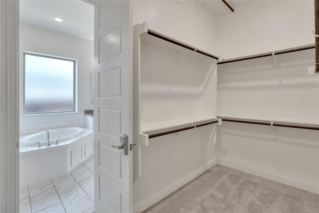 3811 Pepper Grass Lane Prosper, TX 75078 - Photo 33 of 40 a bathroom with a tub and a shower