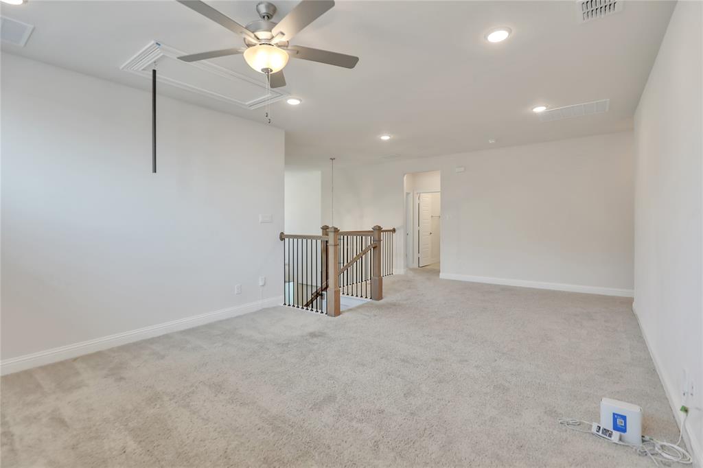 3811 Pepper Grass Lane Prosper, TX 75078 - Photo 36 of 40 an empty room with a ceiling fan and a chandelier fan
