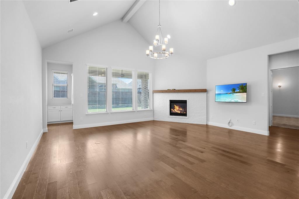 3811 Pepper Grass Lane Prosper, TX 75078 - Photo 4 of 40 an empty room with wooden floor chandelier and glass door