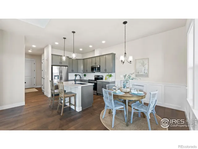 a living room with stainless steel appliances kitchen island granite countertop furniture and a dining table