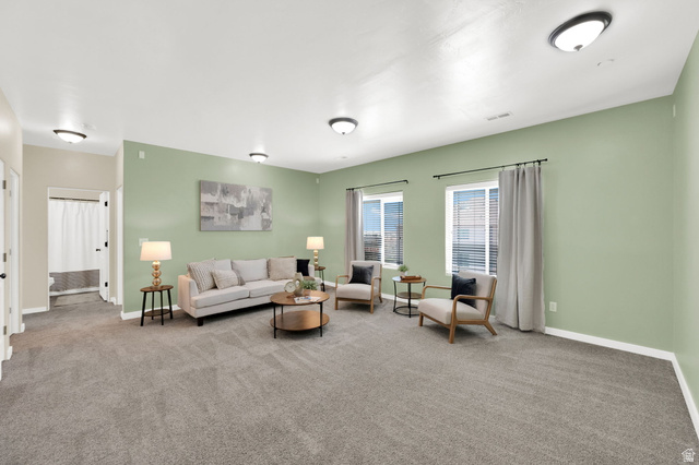 8215 Clear Rock Road, Unit 12 Eagle Mountain, UT 84005 - Photo 5 of 38 Spacious room featuring light green walls, neutral gray carpeting, and multiple windows with blinds