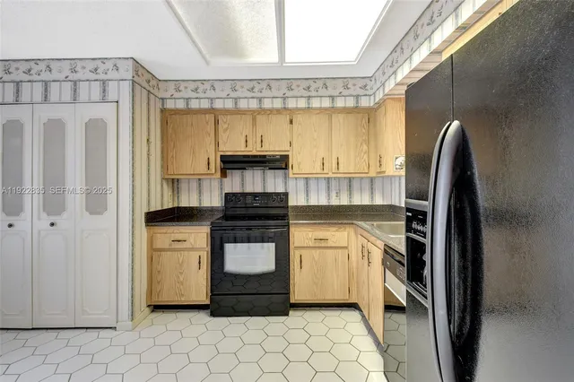 a kitchen with stainless steel appliances a stove a refrigerator and cabinets