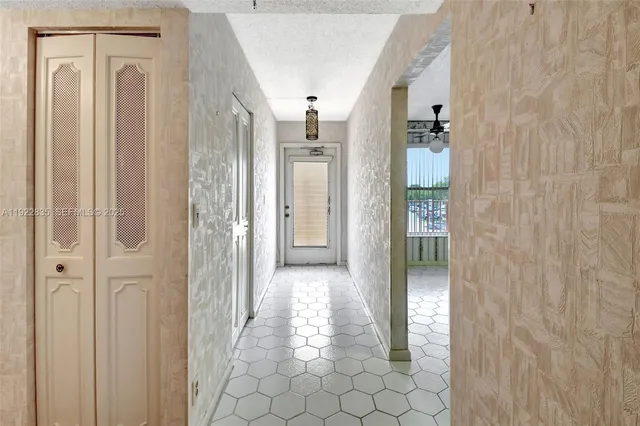 a view of a hallway with wooden shelves