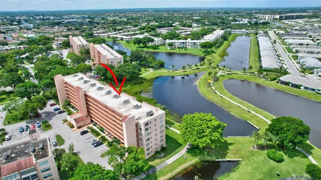 an aerial view of a house with a yard and lake view