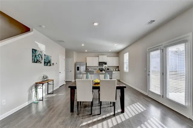 a view of a dining room with furniture and wooden floor