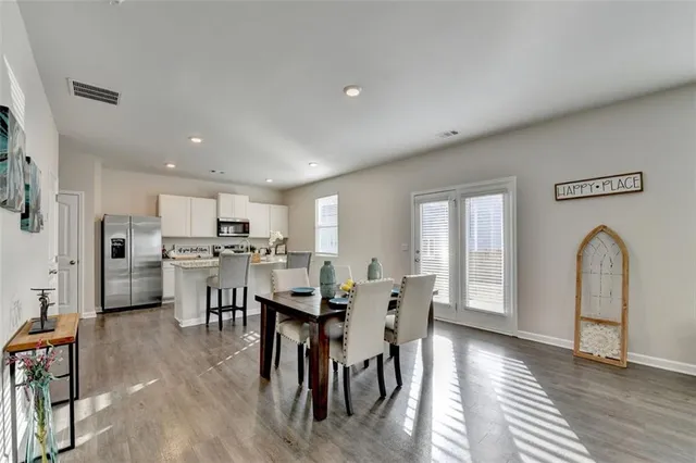 a view of a dining room with furniture and wooden floor