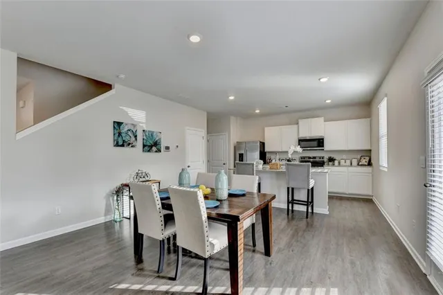 a view of a dining room with furniture and wooden floor
