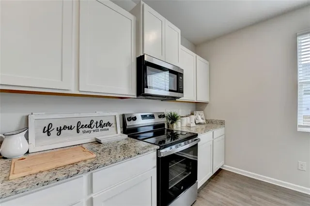 a kitchen with sink and view of living room