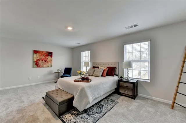 a bedroom with a bed a couch and a window