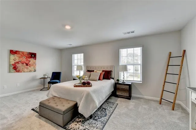 a bedroom with a bed and a couch