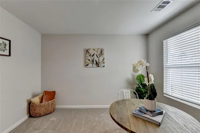 a view of a livingroom with furniture and a potted plant