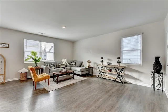 a living room with furniture and wooden floor
