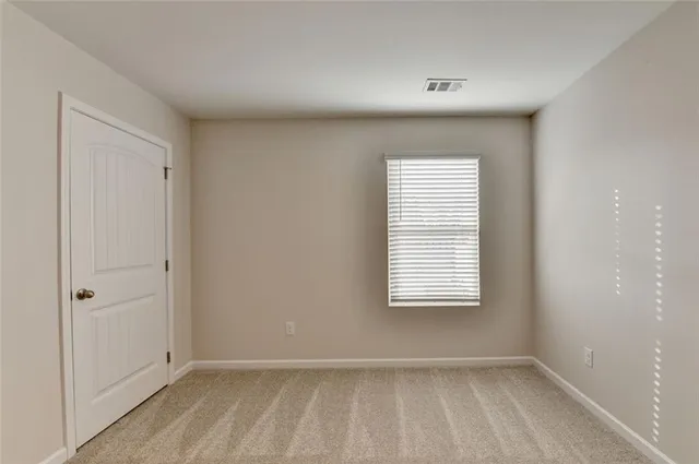 a view of an empty room and entryway