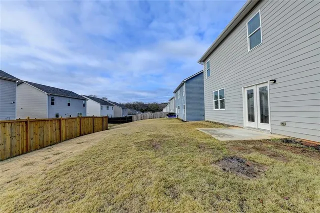 a view of park with swimming pool and lounge chairs