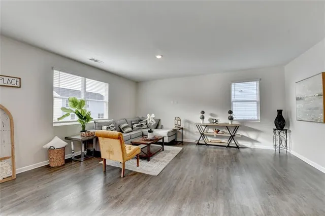 a living room with furniture and wooden floor