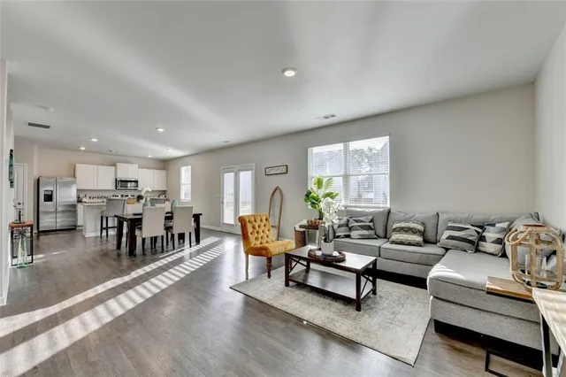 a living room with furniture and wooden floor