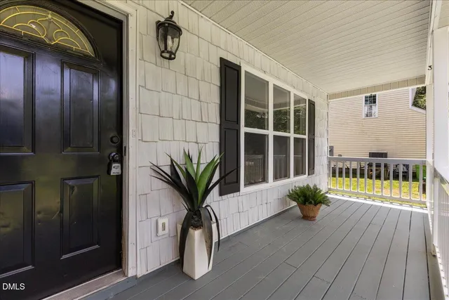 a view of balcony with potted plants and wooden floor