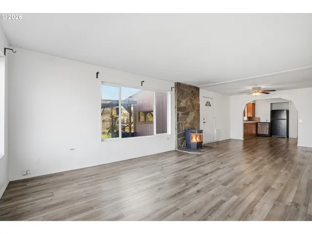 a view of a room with wooden floor