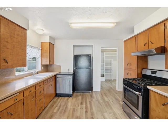 a kitchen with a sink stove and refrigerator