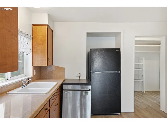 a kitchen with a refrigerator and a sink