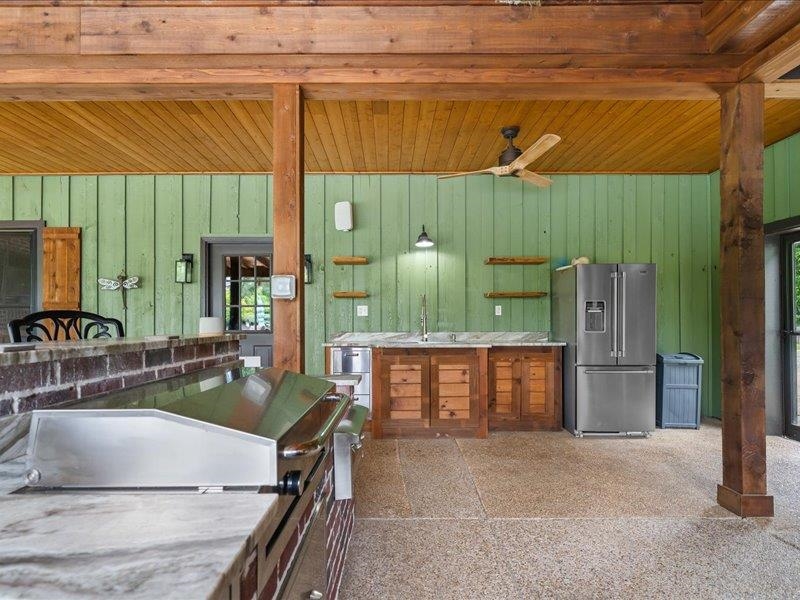 8104 Jack Bond Road Arlington, TN 38002 - Photo 28 of 40 a kitchen with a sink and a refrigerator