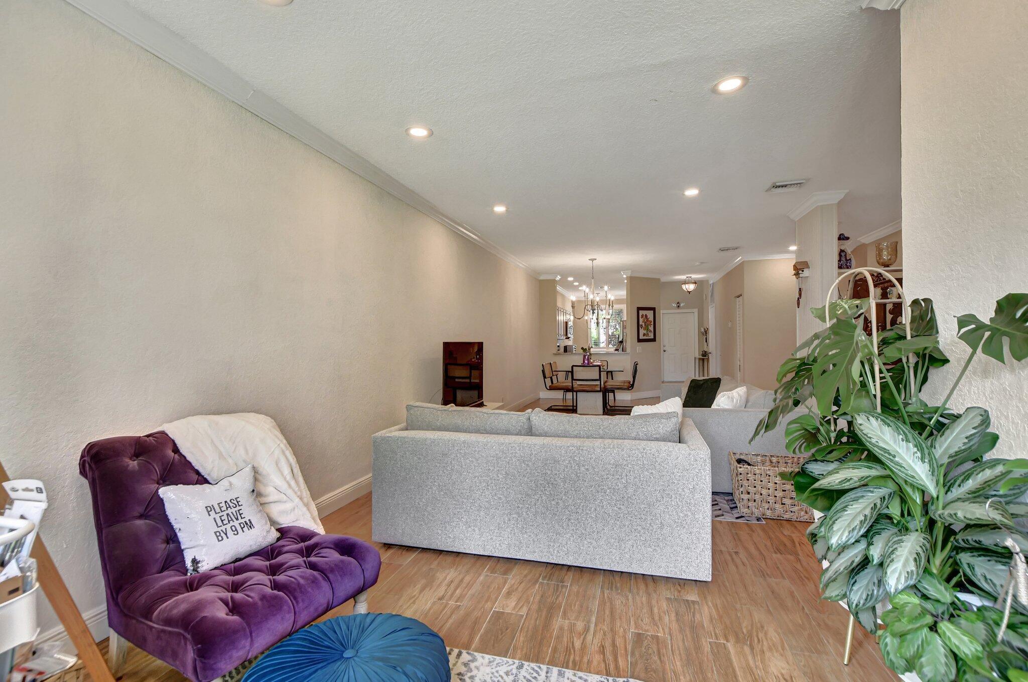 6682 Via Regina Boca Raton, FL 33433 - Photo 30 of 46 a living room with furniture potted plant and a wooden floor