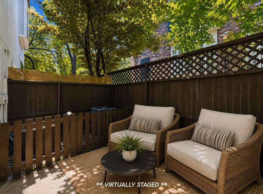 2815 Welborn Street, Unit 101 Dallas, TX 75219 - Photo 22 of 29 Private outdoor patio space featuring dark wood fencing with lattice top details