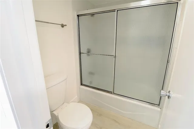 a bathroom with a shower and a toilet