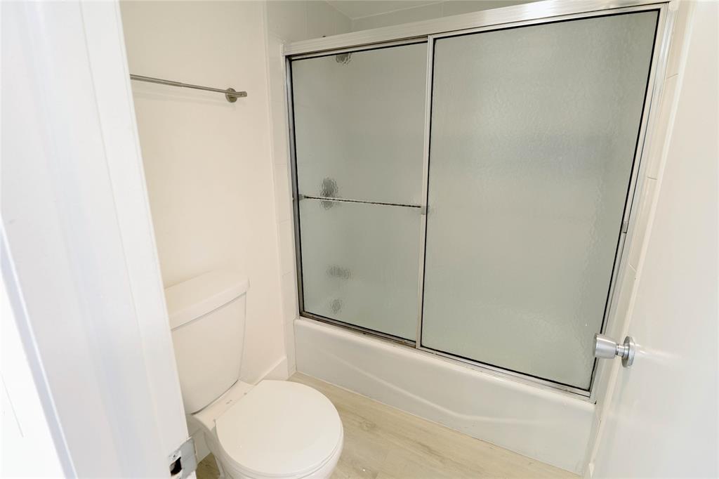 4007 North Cypress Drive, Unit 103 Pompano Beach, FL 33069 - Photo 13 of 25 a bathroom with a shower and a toilet