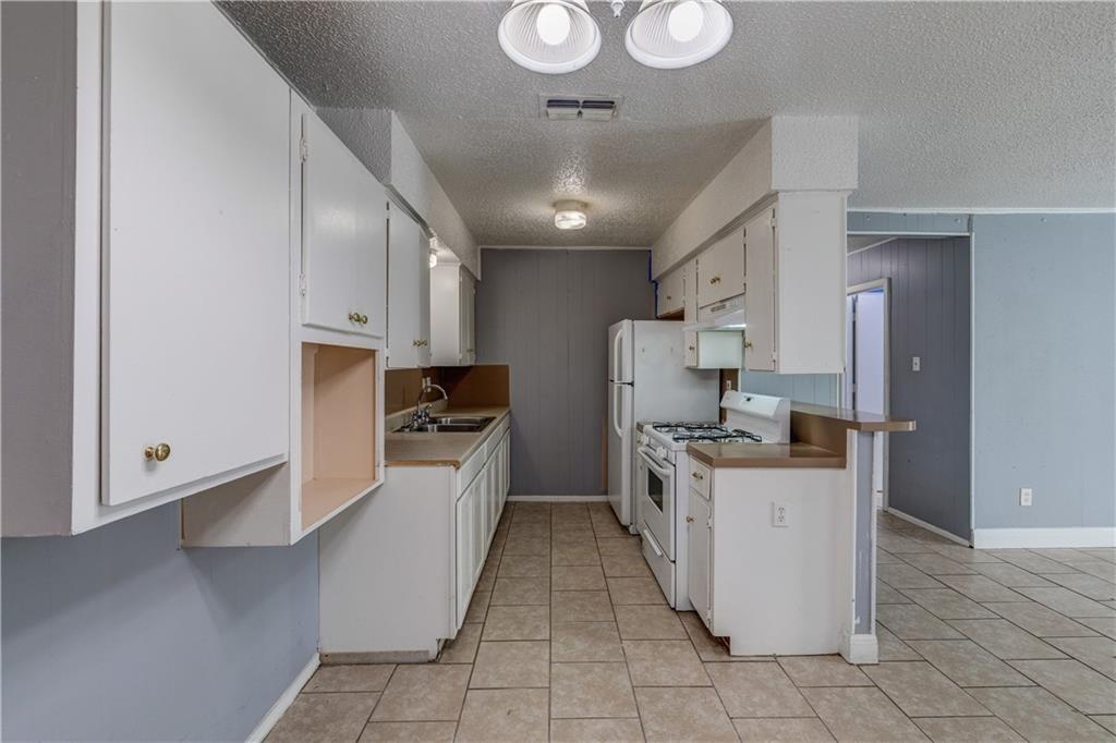1006 Fiesta Street, Unit A Austin, TX 78702 - Photo 5 of 12 a kitchen with stainless steel appliances a stove refrigerator sink and cabinets