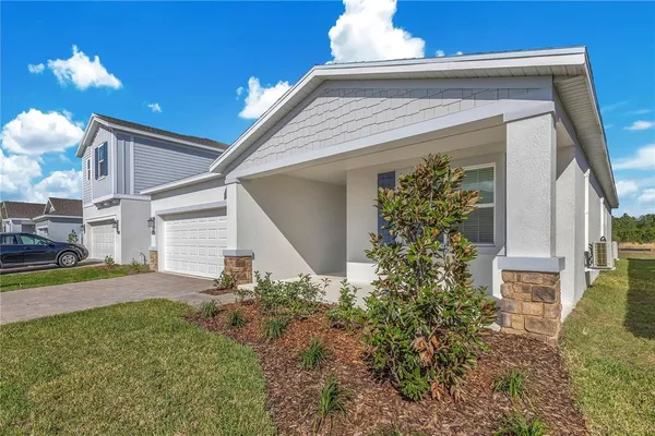 a view of a house with brick walls and a yard