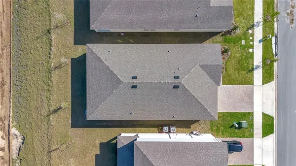 an aerial view of a house with swimming pool and porch